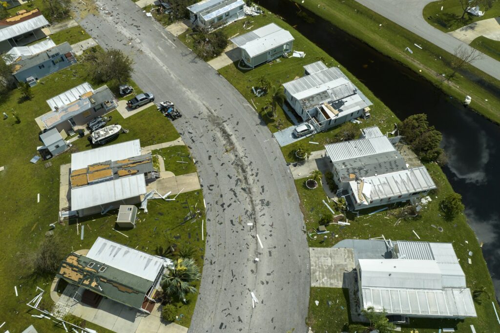 Badly damaged mobile homes after hurricane Ian in Florida residential area.