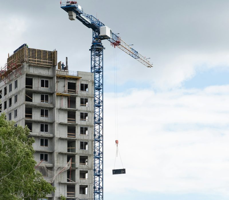 A construction crane on a blue sky background.